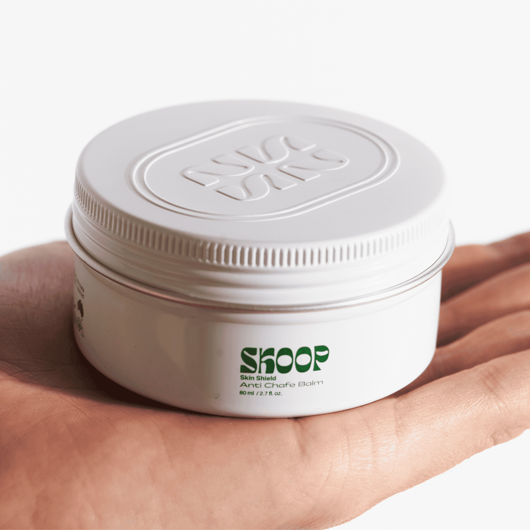 Skoop Skincare, Skin Shield, Anti Chafe Balm. Skoop Skincare tin being held by hand. Skoop Skincare logo visible. 