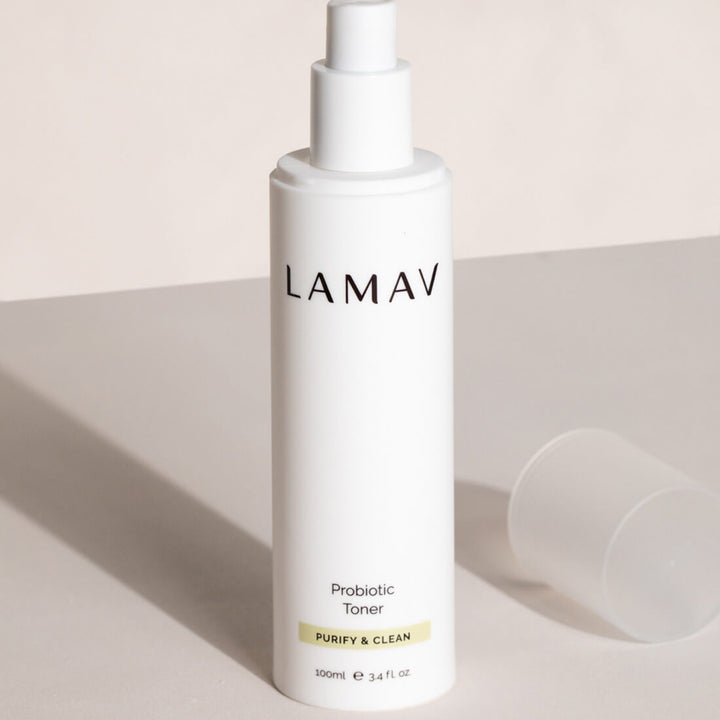 Sleek white bottle of LAMAV Probiotic Toner labeled 'Purify & Clean,' showcased on a plain background, highlighting its minimalistic design and 100ml volume for skincare