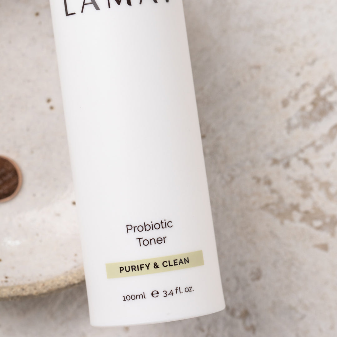 Sleek white bottle of LAMAV Probiotic Toner labeled 'Purify & Clean,' showcased on a plain background, highlighting its minimalistic design and 100ml volume for skincare