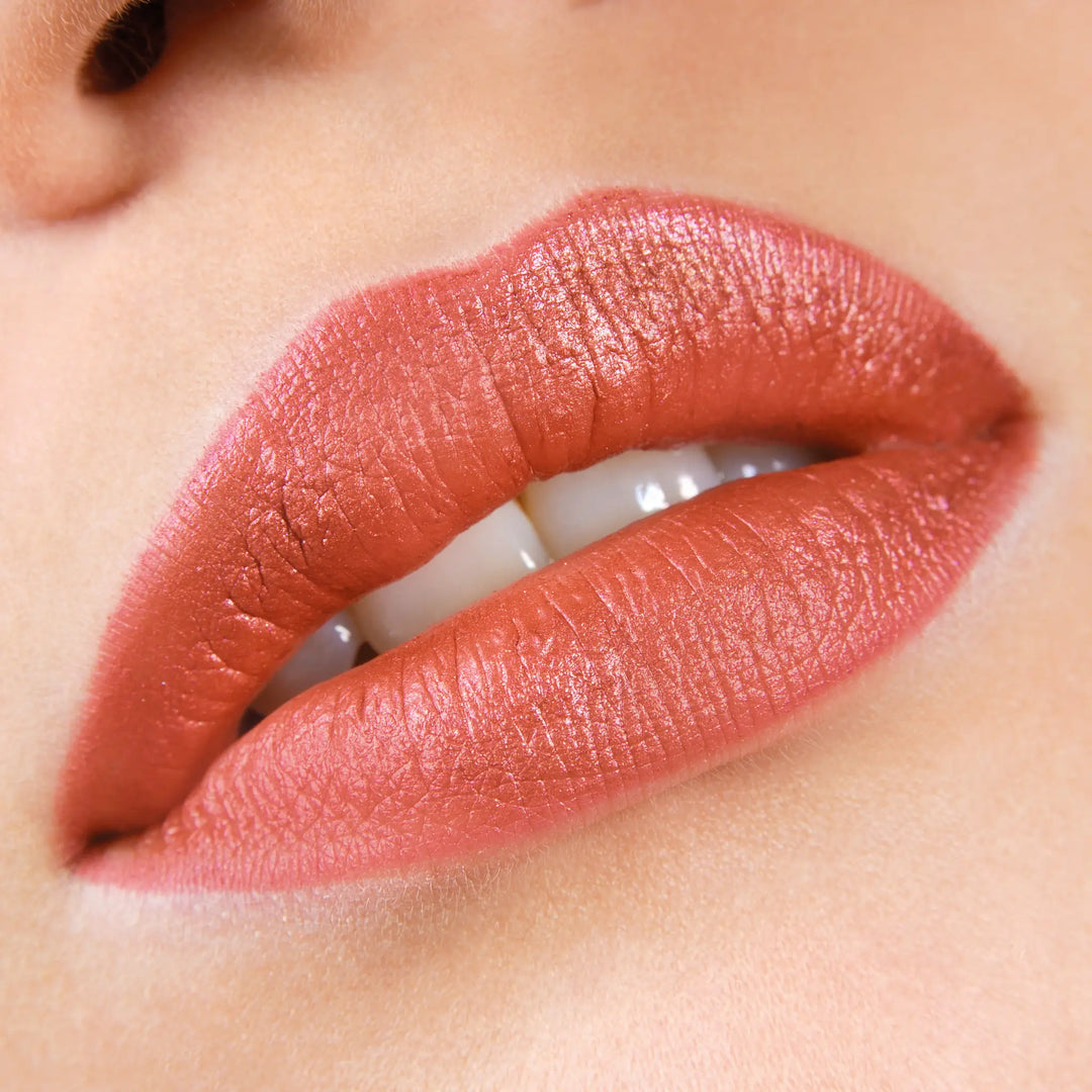 Close-up of lips wearing Avocado Zinc SPF 50 Natural Lip & Cheek Tint in Red Earth, available at VAMS Beauty. This Australian-made tint offers broad-spectrum sun protection and a rich, earthy red hue, perfect for enhancing lip color with a moisturizing and protective formula