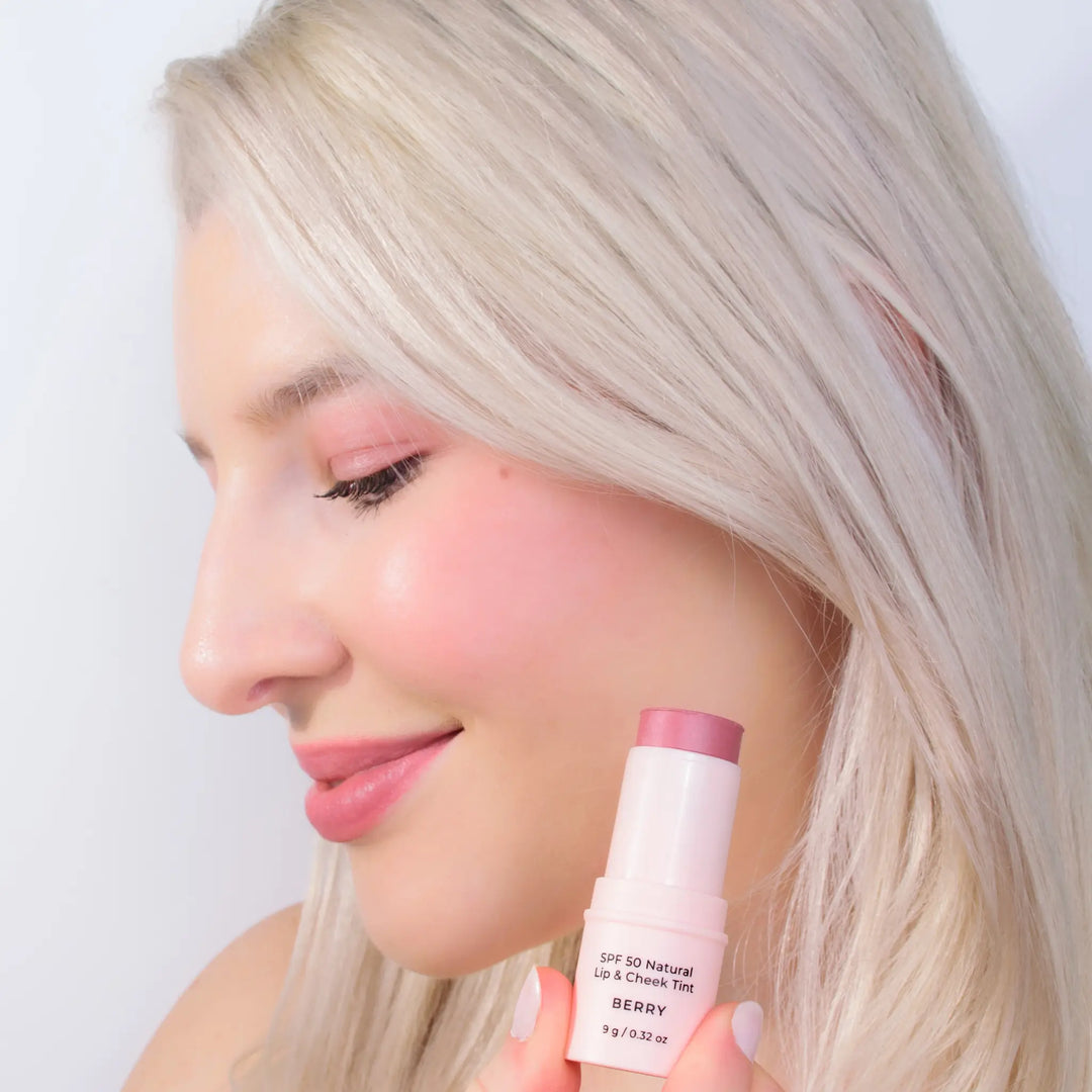 Model applying Avocado Zinc SPF 50 Natural Lip & Cheek Tint in Berry, available at VAMS Beauty. This Australian-made tint provides broad-spectrum sun protection and a natural, rosy hue for lips and cheeks, perfect for enhancing your beauty routine with a moisturizing and protective formula.