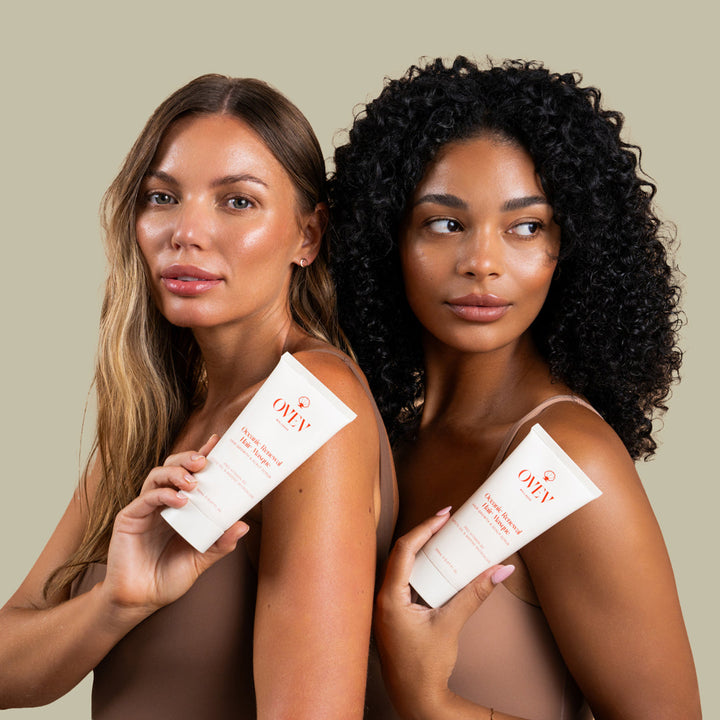 Two women holding OVEV Wellness Oceanic Renewal Hair Masque, showcasing diverse hair types, featuring Pro-Vitamin B5, Sapote Oil, and Marine Microalgae for hair growth and scalp care