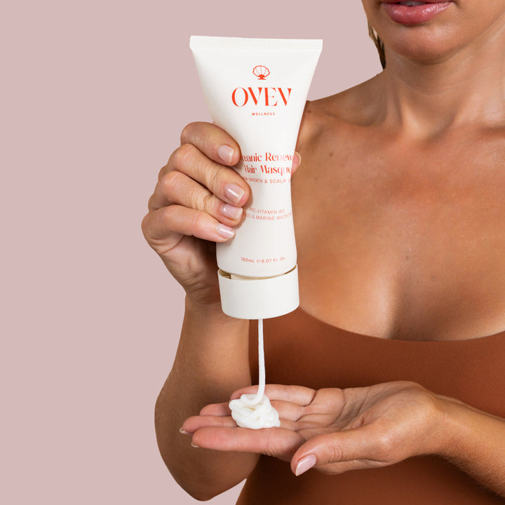 Woman applying OVEV Wellness Oceanic Renewal Hair Masque, rich in Pro-Vitamin B5, Sapote Oil, and Marine Microalgae for hair growth and scalp care, 150ml tube. Best Australian beauty products for better hair growth.