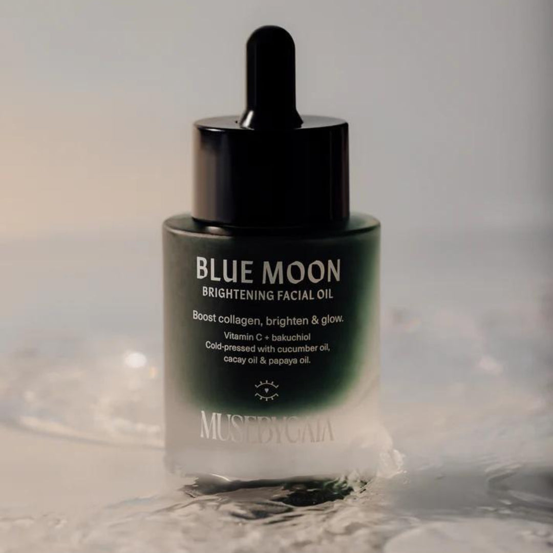 Muse by Gaia's Blue Moon Brightening Facial Oil in a sleek glass dropper bottle, highlighting natural ingredients like Vitamin C, bakuchiol, cucumber oil, cacay oil, and papaya oil for radiant skin.