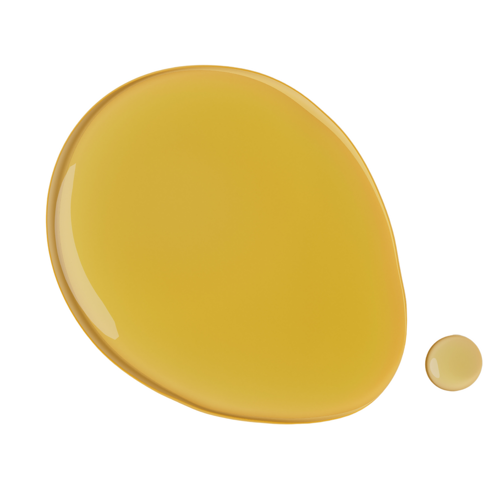 Close-up of a drop of golden, fragrance-free face oil, designed for sensitive skin, highlighting its smooth texture and nourishing properties.