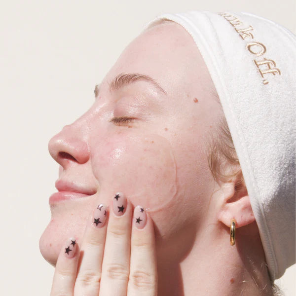 Smiling woman gently applying GunkOff Hydrating Gel Cleanser to her face, showcasing its nourishing and sensitive-skin-friendly formula. Perfect for a refreshing, Australian beauty routine.