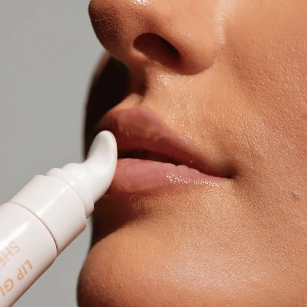 Close-up of model applying VAN-IT Lip Glaze Sheer Gloss for a natural, hydrated shine. Inspired by Rhode beauty. Available at VAMS Beauty, specializing in Australian lip care and beauty products.