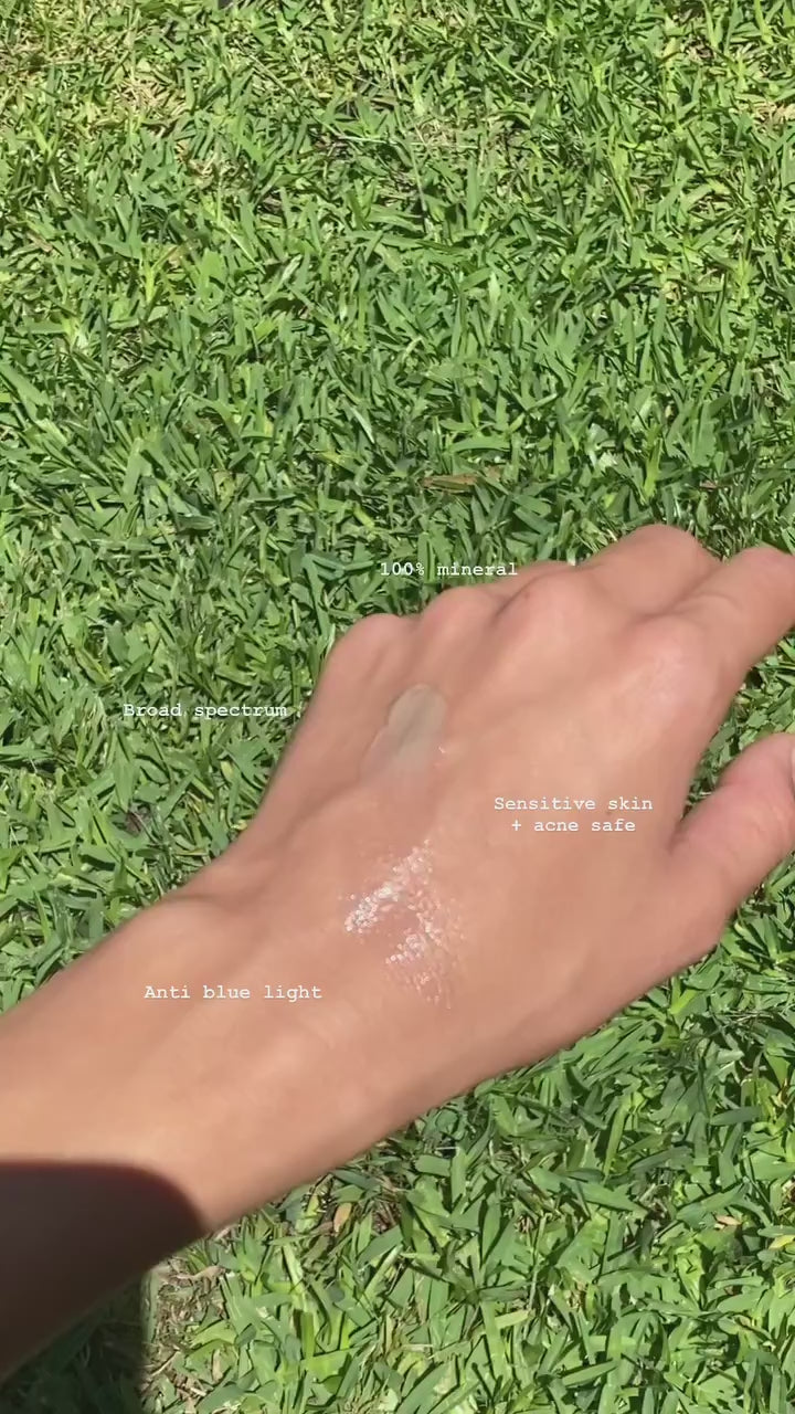 Close-up of a woman applying Glow Filter SPF 50 bronzing mineral sunscreen on her hand, showcasing glowing skin protection with antioxidants, available at VAMS Beauty, your destination for Australian made beauty and skincare products.