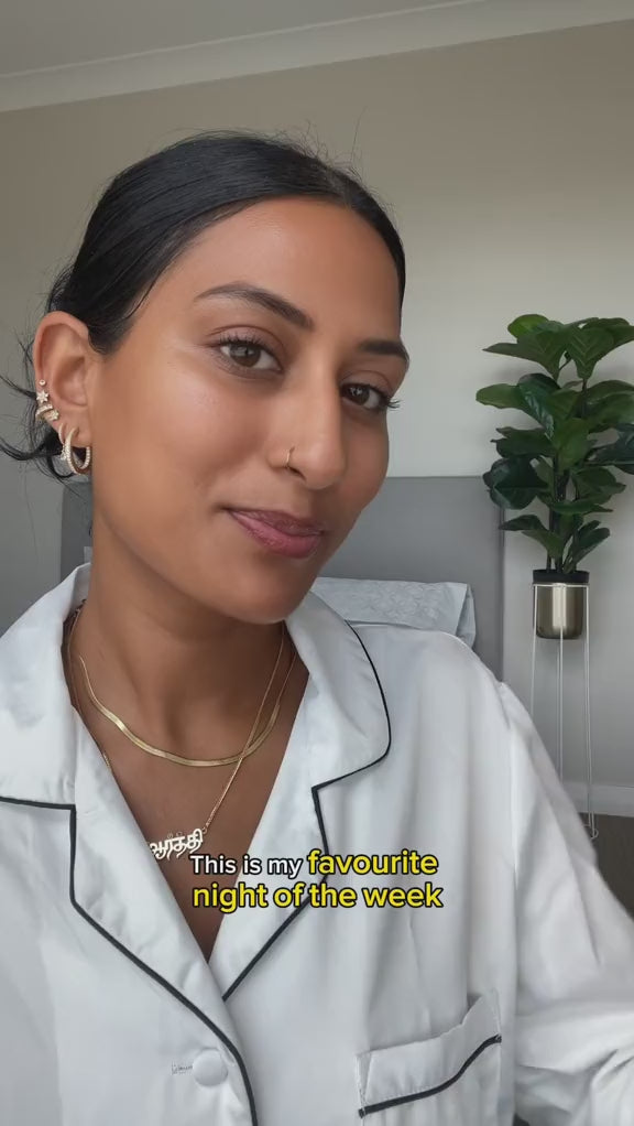 A woman using sneha hair oil as a hair treatment for hair growth. 