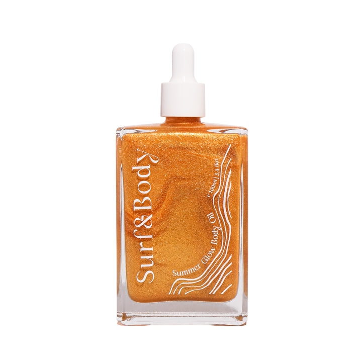 Surf & Body Summer Glow Body Oil in a clear glass bottle, featuring a shimmering golden formula designed to hydrate and enhance the skin with a radiant, sun-kissed glow.