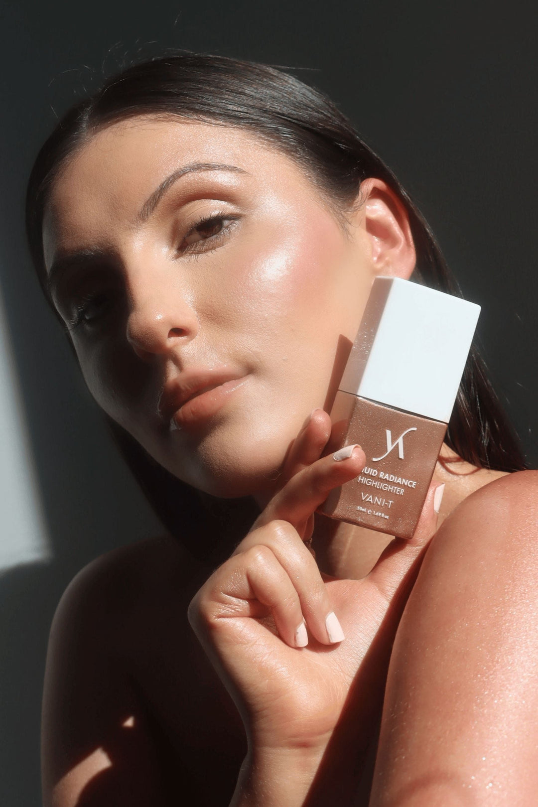 Model showcasing a luminous glow with VAN-IT Liquid Radiance Highlighter, an Australian beauty product for radiant skin. Available at VAMS Beauty, your source for premium makeup essentials.